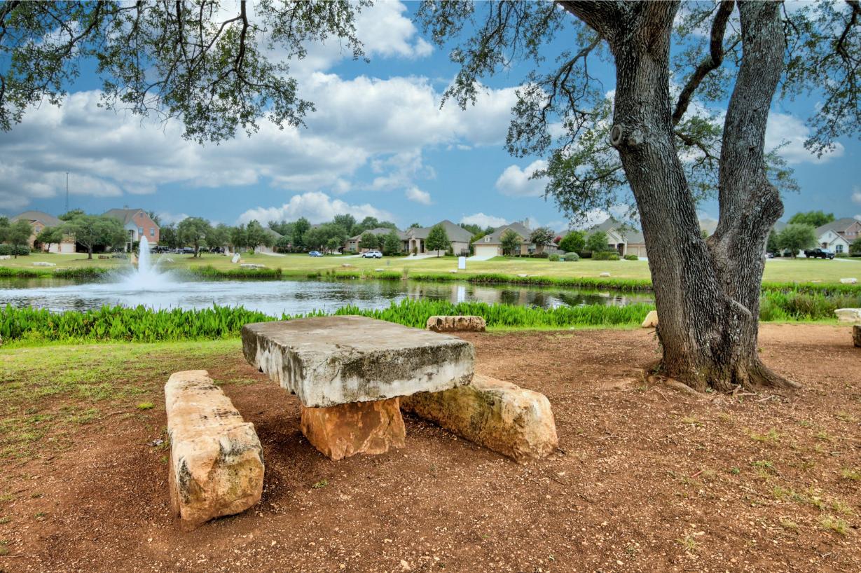 Stone picnic table by pond